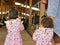 Little baby girls, sisters, visiting an organic dairy farm with her auntie - tour with the kids learning how far does their milk