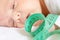 Little baby infant boy head with green centimeter