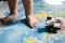 A little baby playing with an aircraft toy on the world map, close up legs, travel with children