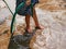 Little baby`s bare feet on wet ground, sand - playing water freely by herself