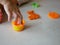 Little baby`s hand collecting and putting playdough back into the box, after finish playing