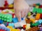 Little baby`s hand picking / choosing a piece of colorful interlocking plastic bricks