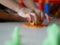 Little baby`s hands applying plastic dough press on the playdough