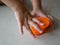 Little baby`s hands closing the plastic box cover, after putting playdough back inside, after finish playing it