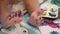 A little baby\'s toes / feet being painted - painting helps developing child\'s hand-eye coordination