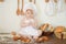 Little baker child in chef hat at kitchen table alone