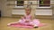 Little ballerina in pink dress doing choreography practice