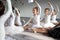 Little ballerinas in ballet studio. Group of happy girls exercising together