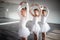 Little ballerinas in ballet studio. Group of happy girls exercising together
