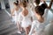 Little ballerinas in ballet studio. Group of happy girls exercising together