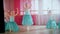 Little ballet girls in blue dresses preparing for the training in the studio
