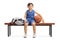 Little basketball player sitting on a wooden bench next to a sports bag