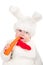 Little beautiful boy in rabbit costume with carrot