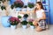 Little beautiful daughter watering flowerpots. The concept of work and lifestyle.