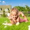 Little beautiful girl finds Easter eggs on green