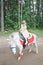 Little beautiful girl rides white pony