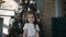 Little beautiful girl standing near a Christmas tree and holding a Christmas gift in the box