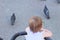 little, beautiful, smiling, cute redhead baby in a pram out-of-doors in a sleeveless shirt and looking forward