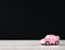 Little beetle pink car in blank background for text, Valentine`s Day concept, Mother`s Day concept, macro shot.