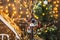 Little bird houses painted with snowmen on a thin tree decorated Christmas