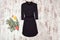 Little black dress with sleeves and spruce branch