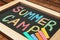 Little blackboard with text SUMMER CAMP chalked