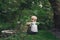 Little blond boy sitting on grass in the Park. Independent child