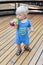 Little blond child infant drinking juice on the playground