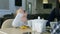 Little blond girl drinking tea sitting in cafe with her lovely parents.