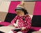 Little blond girl in the headphones with the tablet