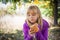 Little blond girl on a picnic in autumn park