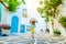 Little blond girl standing on the courtyard on greek street