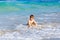 Little blond kid boy having fun on ocean beach in Florida