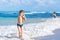 Little blond kid boy having fun on ocean beach in Florida