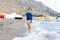 Little blond kid boy running ocean beach