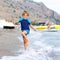 Little blond kid boy running ocean beach