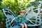 Little blond preschool kid boy discovering flowers and butterflies at botanic garden. Schoolchild interested in biology