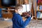 Little blond preschool kid boy playing with toy ship indoors