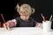 Little blond toddler girl making a drawing