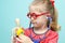 Little blonde girl with red glasses listen heart with stethoscope.