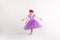Little blonde girl wearing purple fairy princess dress on white background. Kids costume for new year party