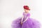 Little blonde girl wearing purple fairy princess dress on white background. Kids costume for new year party