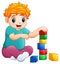 Little blonde haired boy sitting and playing with toy cubes