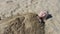 Little blonde haired girl getting buried in sand