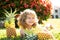 Little blonde kid hugging pineapple on nature background. Childhood, healthy nutrition, advertising. Close up kids funny