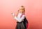 Little blonde schoolgirl points advertisement, solution promotion,  on yellow background