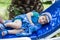 Little blonde toddler boy in swimm suit on couch