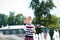 Little blondy girl playing with soap bubbles in summer park