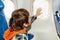 Little boy on airplane touch window with hand