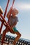 Little boy on a balance swing, in a beach background